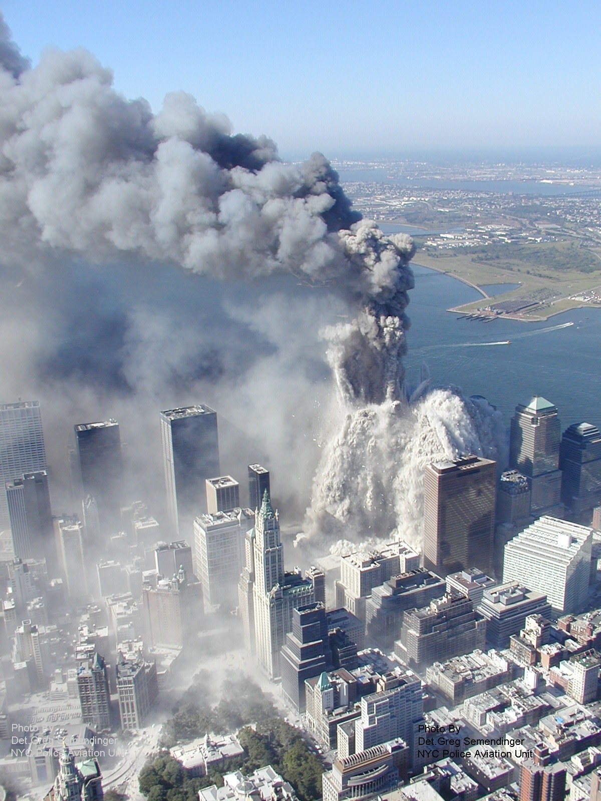Figure 1. (9/11/01) Aerial view of WTC1 during the destruction, showing massive dust cloud engulfing lower Manhattan.
<br>
- Photo by Det Greg Semendinger, NYC Police Aviation Unit
