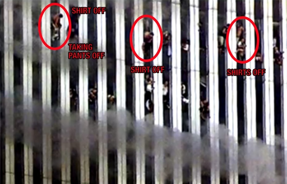 Figure 123. (9/11/01) Close-up view showing occupants actively removing trousers while hanging by one hand or foot over 1000-foot drop, demonstrating dielectric heating response.<br> Photo by Jeff Christensen/REUTERS