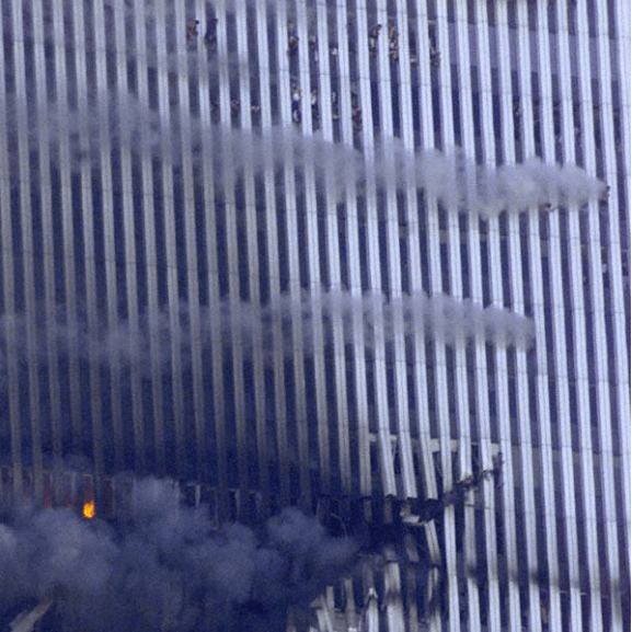Figure 122. (9/11/01) Group of occupants hanging outside 105th floor windows of WTC1, showing disrobing behavior.<br> Photo by Jeff Christensen/REUTERS