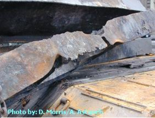 Figure 72. (2001 - 09/2002) Steel beam showing extreme section loss with curled flanges and no visible slag pile, demonstrating dry erosion and field-mediated material removal. Steel from the site of Building 7. Photo by D.Morris/A.Astaneh (Principal Investigator, Abolhassan Astaneh-Asl)