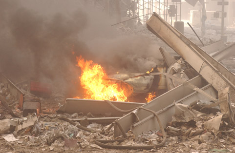 Figure 57. (9/11/01) Ground-level vehicle with nearby plastic waste bucket and Igloo cooler (dielectric survival adjacent to altered vehicle)