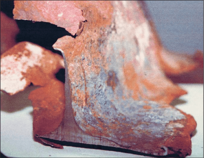 Figure 67. (2001-02) Close-up of a highly-eroded wide-flange steel beam section with extreme erosion, flanges thinned to millimetric thickness exhibiting laminar exfoliation. Beam section "appeared to be from WTC7" (according to FEMA report [Ref: FEMA 403, Appendix C])<br>- Image by FEMA
