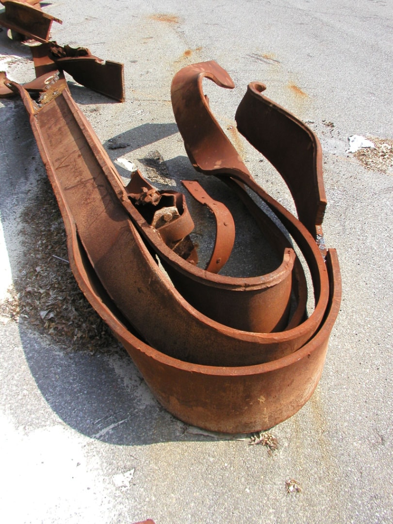 Figure 39. WTC I-Beams Bent around the wrong axis. Monolithic steel column exhibiting smooth upward curl along its length, similar to bimetallic strip, demonstrating differential strain.
  <br>
  - Image by NIST.