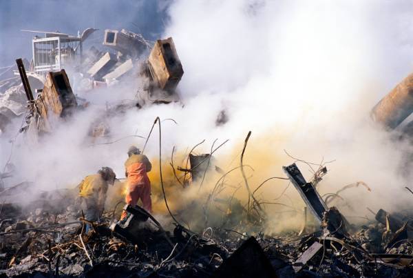 Figure 61. (9/??/01) Workers at Ground Zero using Oxy fuel torch, the hose touching the rubble from pressurized tanks and not exploding from "high heat".<br>- Photo by FEMA