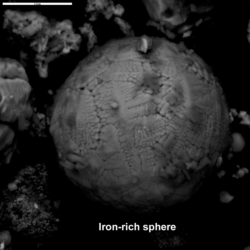 Figure 82. (4/28/05)(10μm - scale) Iron-rich sphere found in dust from the WTC. Using the scale on the image, the diameter of the iron-rich sphere is about 25μm.Microscopic analysis showing perfect iron-rich sphere approximately 25 micrometers, demonstrating localized transient softening and surface-tension spheroidization.<br>- Image by United States Geological Survey
