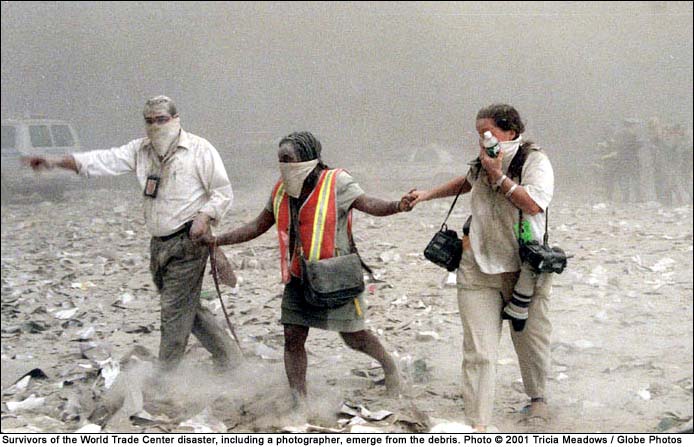 Figure 77. (9/11/2001) Fine and finer dust rises from the ground. Suspended particulate cloud or electro-static aggregates surrounding feet of pedestrians 15-20 minutes post-event, demonstrating athermal aerosol emission.  Photo by Tricia Meadows/Globe Photos