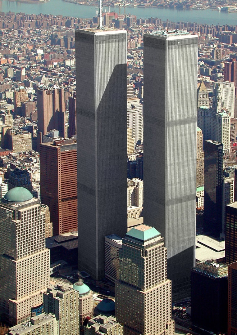 Figure 12. (~ March 2001) Aerial view of World Trade Center, and surrounding area of New York, Downtown Manhattan is in the foreground, looking northeasterly.<br>- Photo by Jeff Mock