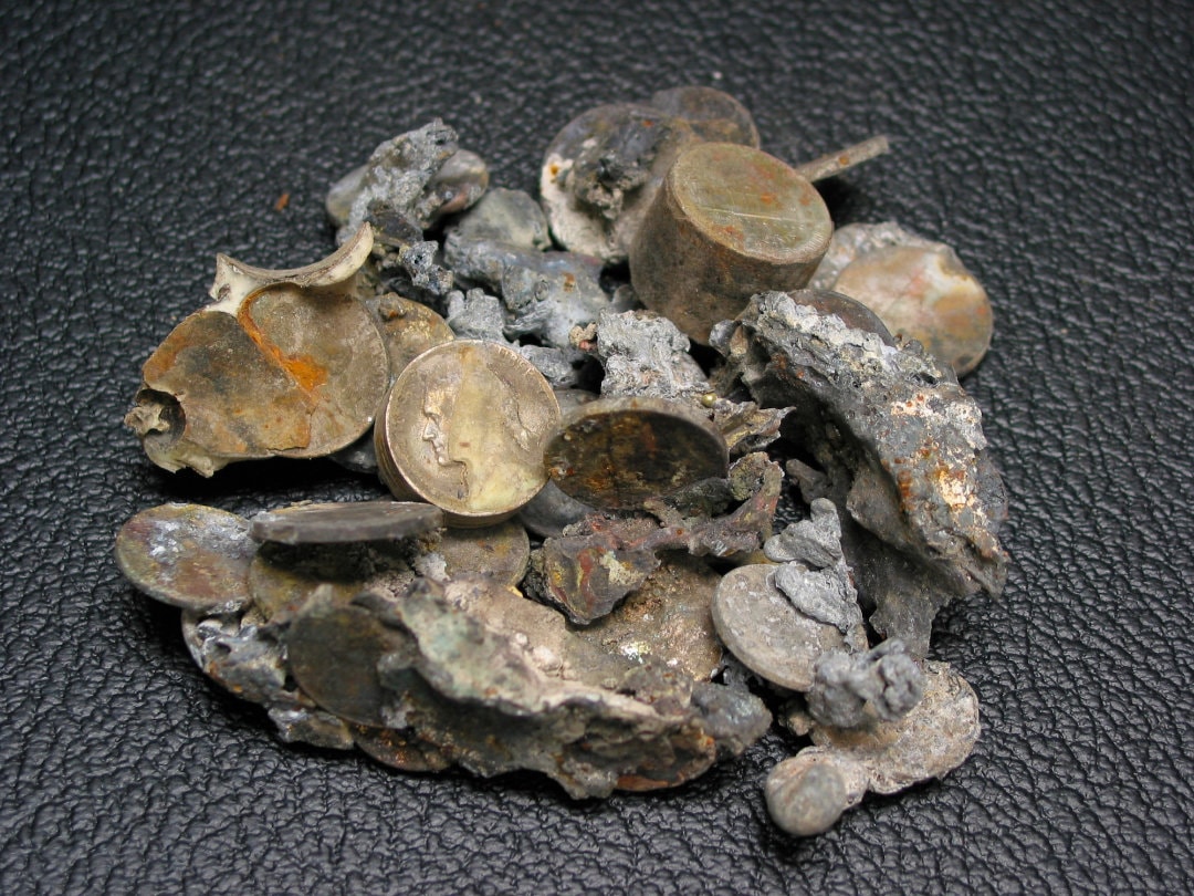 Figure 34. Group of fused coins recovered from the debris of the World Trade Center. Fused cluster of U.S. coinage containing zinc-rich pennies and copper-nickel coins with individual minted relief and geometric integrity preserved