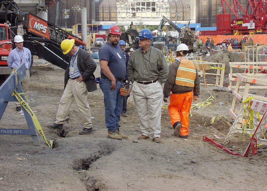 Figure 116. (10/10/01) Damage to slurry wall from earth-moving equipment along Liberty Street, demonstrating that cleanup operations caused more damage than the tower collapse event. FEMA Director tours with WTC worker.<br>- Image by FEMA
