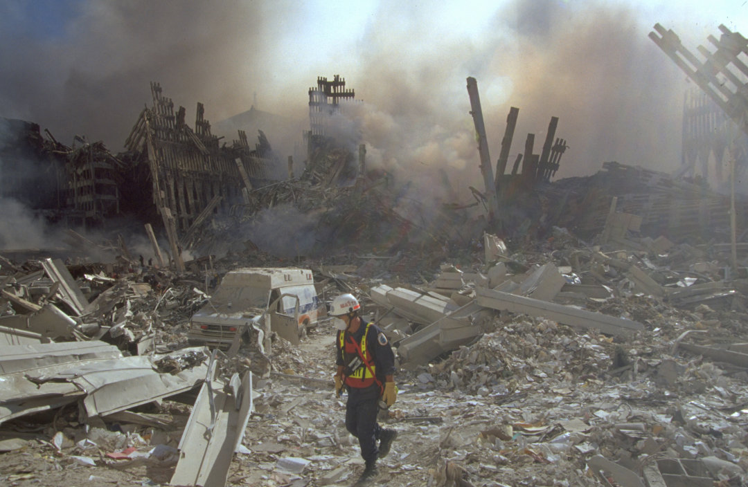 Figure 13. (9/13/01) Ground level view looking east, in front of where WTC1 once stood showing minimal debris pile, less than 2% of original building height.
  <br>
  - Photo by FBI