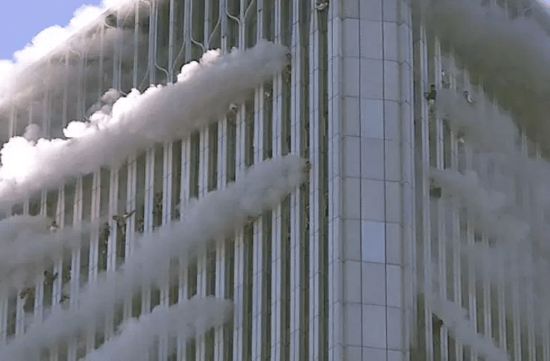 Figure 126. (9/11/01) Stream of fumes emerging from northwest corner of WTC 1 ejected in rigid horizontal vector away from building face, demonstrating dielectrophoretic plume forcing.<br>- Image by Jose Jimenez/Primera Hora