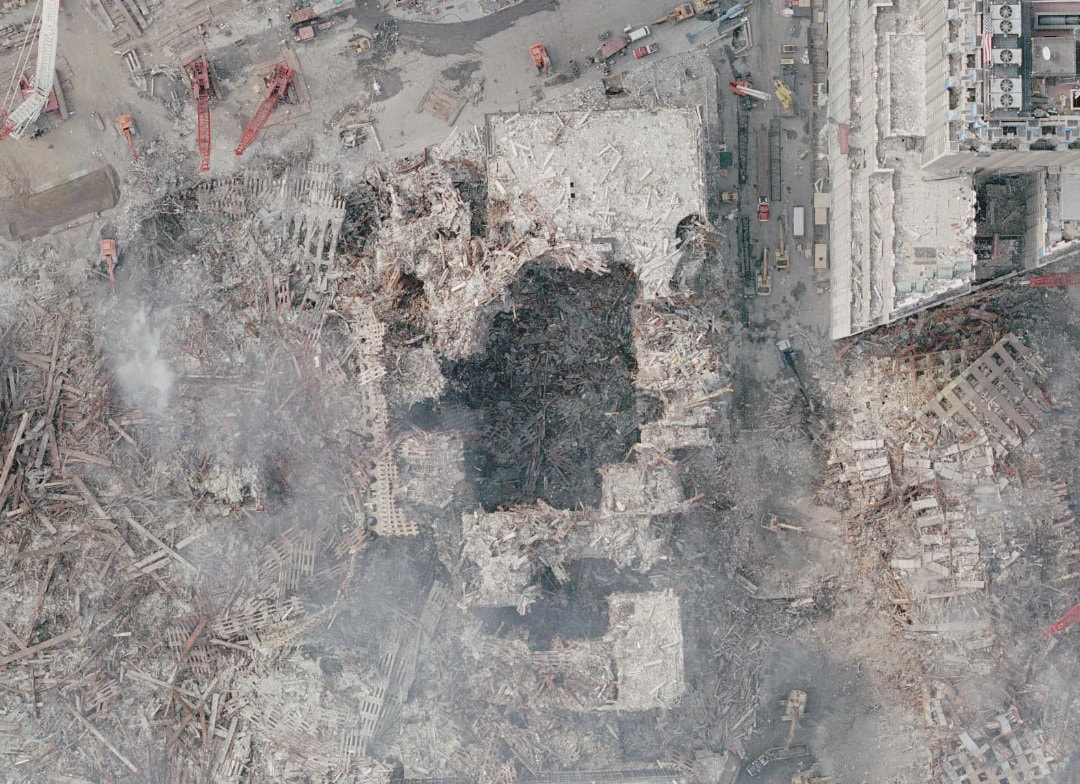 Figure 96. (9/21/01) Close up of a NOAA aerial photograph showing WTC 6 with visible cylindrical vertical holes cutting through multiple floors. Cylindrical holes were seen in WTC5 and WTC6.<br>- Photo by NOAA's Cessna Citation Jet 3,300 feet above.