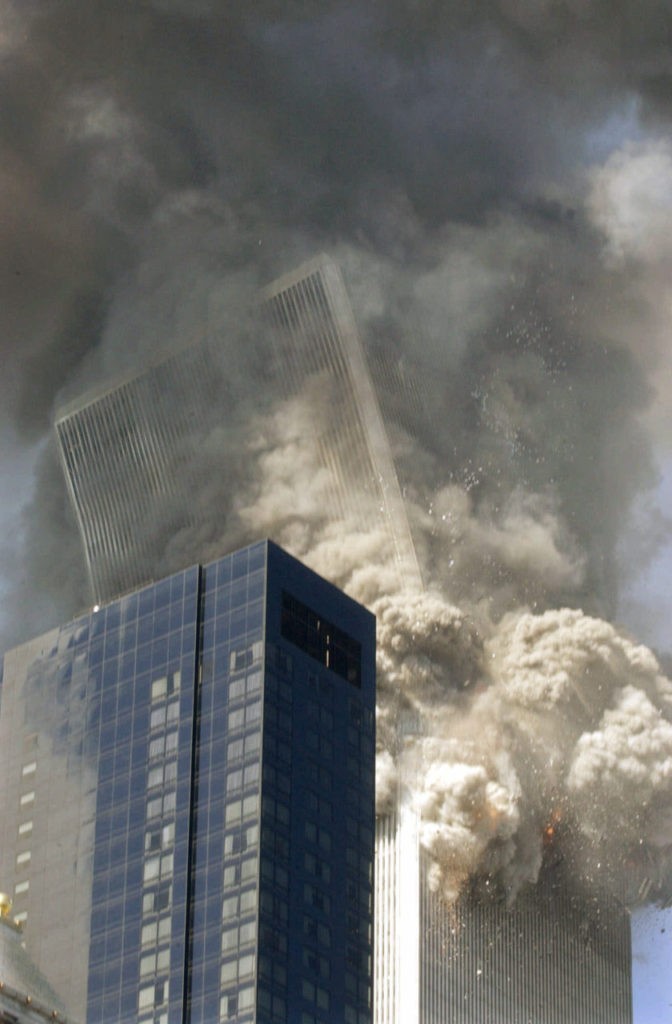Figure 85. (9/11/01) WTC2 upper section beginning to tilt, showing initial angular momentum before spherical aerosolization<br>- Image by Amy Sancetta/AP