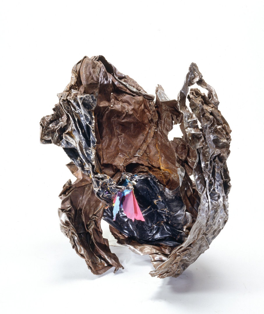 Figure 30. File Cabinet from a Ben & Jerry's ice-cream shop under the WTC complex. The paper retained its color, indicating this file cabinet did not shrivel due to conventional heat. Fused filing cabinet artifact showing paper documents embedded in resolidified ferrous metal matrix, with paper fibers visible and legible without carbonization