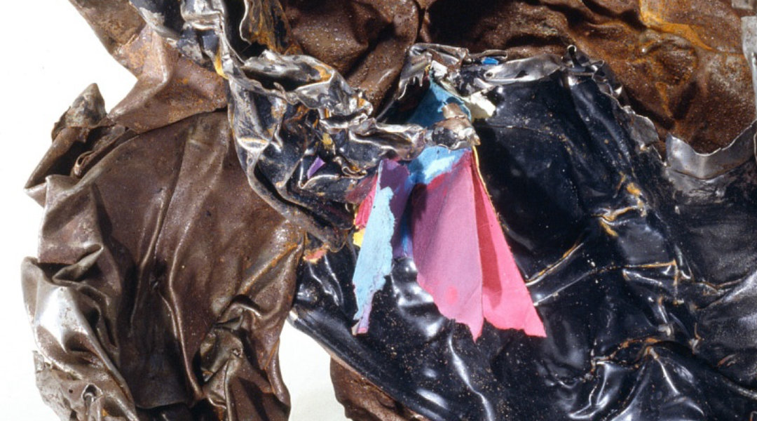 Severely altered ferrous filing-cabinet material with colored paper preserved at the interface